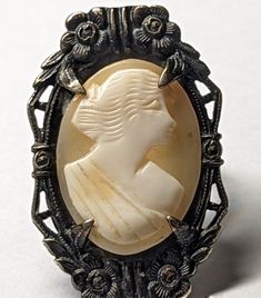 Ornate Cameo Jewelry For Anniversary, Antique Formal Jewelry With Cabochon, Vintage White Gold Oval Cabochon Ring, Vintage Sterling Silver Cameo Ring, Vintage Formal Cameo Engraved Ring, Vintage Cameo Engraved Ring For Formal Occasions, Formal Cabochon Sterling Silver Rings, Elegant Antique Silver Cabochon Jewelry, Formal Cabochon Ring In Sterling Silver