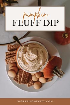 a white plate topped with crackers and pumpkin fluff dip