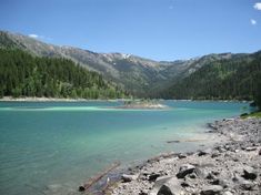 a lake surrounded by mountains and trees