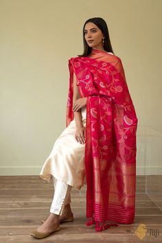 "\nAn effortlessly beautiful dupatta! It has a gracious floral pattern in roopa sona and antique zari and a\u00a0refined\u00a0border and aanchal, making it versatile and charming addition to any ensemble.\n\u00a0\n\n\n\nColor\u00a0-\u00a0A delightful\u00a0shot colour with a warp of\u00a0Red and a weft of  Rani Pink\n\n\nTechnique\u00a0-  Fine\u00a0Meenakari technique which\u00a0involves the painstaking addition of supplementary coloured resham threads during the hand-weaving process.\n\n\nFabric Dupatta Photoshoot, Holi Dress, Banarsi Suit, Saree Pins, Banarsi Dupatta, Dupatta Designs, Combination Dresses, Kurti Sets, Neat Casual Outfits