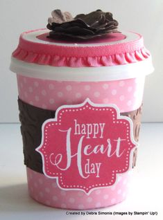 a pink and brown cup with a happy heart day tag on it