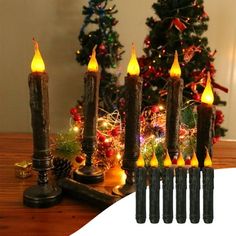 six lit candles sitting on top of a table next to a christmas tree and other decorations