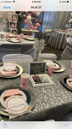 the table is set with pink and silver decorations