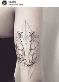 an elephant tattoo on the right thigh with flowers and leaves around it's head