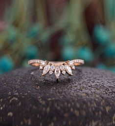 a diamond ring sitting on top of a rock