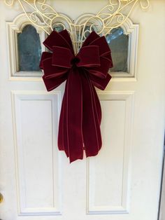 a red bow hangs on the front door