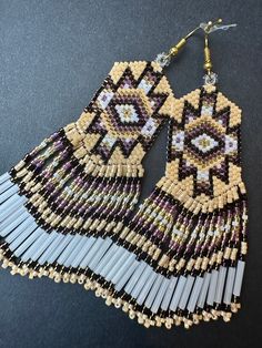 Handmade beaded fringe earrings are a fusion of tradition, artistry, and contemporary Native American design. Each piece of jewelry is unique. Additional photos in listings are to show you our large range of styles and colors.  *CUSTOM ORDERS ACCEPTED. PLEASE ALLOW 2-4 WEEK TURNAROUND FOR CUSTOM COLORS AND EARRINGS.* Browse our shop: https://nativeamericancurio.etsy.com  About Native American beadwork/fringe earrings also known as "shoulder dusters": Native American beadwork is an art form creat Traditional Fringe Beaded Earrings With Round Beads, Traditional Beaded Earrings With Fringe And Round Beads, Traditional Fringed Beaded Earrings, Traditional Beaded Earrings With Beaded Fringe, Artisan Beaded Earrings With Fringe, Native American Inspired Fashion, Mode Coachella, Bead Fringe Earrings, Earrings Native American