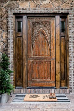 an ornate wooden door on the side of a stone building