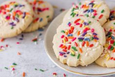 several cookies with sprinkles on a plate