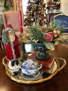 a tray with christmas decorations on it and a santa clause figurine in the center