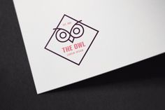 the owl logo is displayed on a white paper