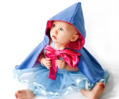 a baby dressed in a blue and pink outfit