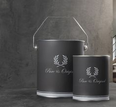 two metal buckets sitting next to each other