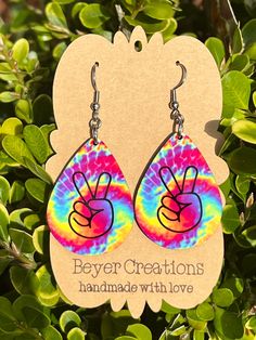 USA Made Tie dye PEACE earrings Lightweight handmade earrings . Earring images are sublimated onto hardboard. Design is on both front and back of earrings. Charm is approximately 1.5 inches long and hangs at 2in with hook earring. Nickel free. Peace Sign Earrings, Peace Earrings, Valentine Favors, Boho Jewelry Diy, Homemade Earrings, Photo Layers, Boho Ring, Wood Earrings, Earrings Dangle