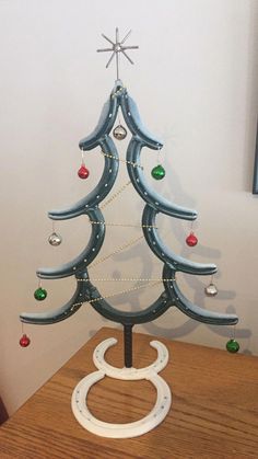 a small wooden christmas tree on a table