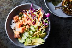 two bowls filled with different types of food on top of a stone table next to each other