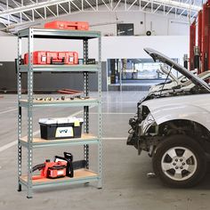 a white truck parked in a garage with its hood open and tools on the rack