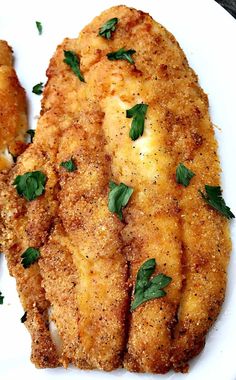 fried fish with parsley on top and the words air fryer 3 ingredient fried catfish