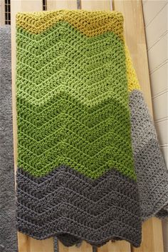 a crocheted blanket sitting on top of a wooden table