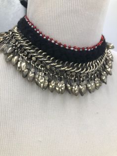 * This beautifully handcrafted silver color shade necklace is the epitome of tradition. The metallic weaving technique and dangling beads at the bottom are flaunting all the tribal vibes. The thread work at the top has complimented the whole theme of the necklace. You can pair this elegant piece of craft with any traditional or trendy outfit. Note: The product is handmade, slight change might occur in the actual product. Traditional Metal Choker For Festivals, Traditional Metal Choker With Oxidized Finish, Festive Traditional Oxidized Finish Choker, Festival Oxidized Choker Necklace, Afghani Jewelry Choker, Hand Cuff Bracelet, Boho Cuff Bracelet, Kuchi Jewelry, Boho Cuff