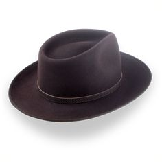 Description Materials Craftsmanship Hat Care Shipping Returns Product Description A Stylish and Functional Men's Western Fedora Elevate your rustic style with the Ulysses, a men's western fedora handcrafted from luxurious rabbit fur felt. Featuring a smooth finish and a distinctive teardrop crown, this hat combines classic western flair with modern sophistication. With a 4 3/4" crown height and a 2 7/8" ribbon-bound snap brim, the Ulysses strikes the perfect balance between style and functionali 1940 Style, Outdoor Hut, Hats For Big Heads, The Raid, Mens Western, Homburg, Color Chocolate, Crown Design, Leather Hats