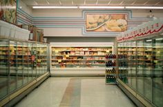 an empty grocery store aisle with lots of food in the aisles and on display shelves