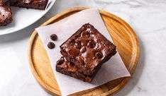 two plates with brownies on them and one has chocolate chips in the middle as well