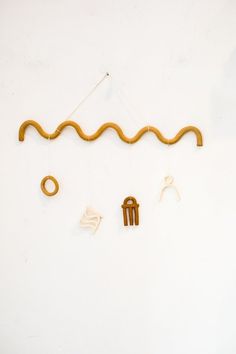 a white wall with various objects hanging from it's sides, including an object that looks like a snake