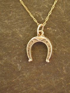 "This Horse Shoe pendant is 14K Gold. The included chain is a 14K Gold chain. You may choose 16, 18 or 20 inch at the same price. Other length available at sightly higher prices. This Horse Shoe pendant measures 5/8\" tall by 1/2\" across. I hand cast all my pieces using the lost wax casting method. Please ask your needs. You may call me with questions, often I am out so please use my machine. 831-476-3176. Satisfaction Guaranteed! I send items USPS First Class unless otherwise directed. I send Horse Shoe Pendant, Gold Engraved Horseshoe Jewelry, Classic Yellow Gold Necklaces For Good Luck, Classic Engraved Jewelry For Good Luck, Shark Pendant, Silver Shark, Dope Jewelry Accessories, Celtic Knot Pendant, Horse Pendant