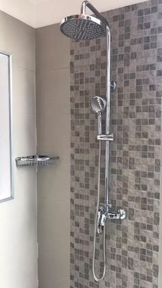 a shower head with thermostaer and faucet mounted to it's side