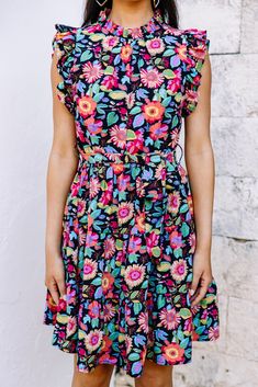 This bold dress is stunning! It's going to look so fabulous this spring and summer! This dress may have a black background but it doesn't make it any less perfect for the season! Those vibrantly colors flowers truly pop against it! This dress is going to look amazing with heels, sneakers, or sandals! Round neckline Button keyhole back Ruffled cap sleeves Tied waist Vibrant floral print No stretch Cindy is wearing the small. Bold Dress, Bold Dresses, Heels Sneakers, Black Floral Dress, Mint Julep Boutique, Floral Dress Black, High Neckline, Black Background, Black Floral