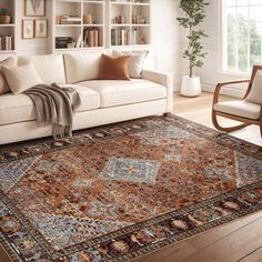 a living room filled with furniture and a large rug