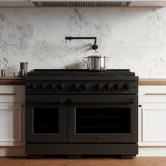 a black stove top oven sitting inside of a kitchen next to a wall mounted range