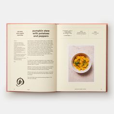 an open book with a bowl of food on the cover and title page in it