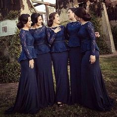 three women in blue dresses standing together