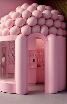 there is a pink room with lots of balls on the walls and in the doorway