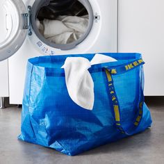 a laundry bag sitting next to a washing machine