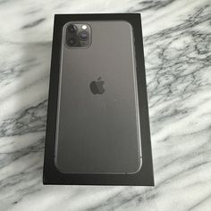 an iphone in its box sitting on a marble counter top with it's back facing the camera