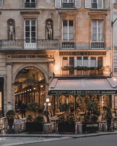 the outside of a cafe in paris at night