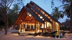 an outdoor pavilion lit up at night on the beach