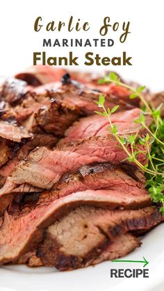 garlic soy marinated flank steak on a white plate