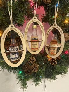 three wooden ornaments hanging from a christmas tree