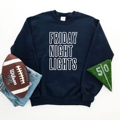 Friday Night Lights graphic on front in black. Adult Sizes S-XXL (unisex sizing)Youth Sizes S-XL (unisex sizing) For all Friday Night Lights Sweatshirts click here to view.For all Friday Night Lights Tees click here to view.Gildan 18000 Heavy Blend, Port & Co, Jerzzees (availability varies)50/50 cotton/polyesterClassic, unisex fit1x1 rib with spandex Sweatshirt Colors, Heather Grey Sweatshirt, Camp Style, Diy Halloween Projects, Sewing Workshop, Friday Night Lights, Green Sweatshirt, Football Outfits, Night Lights