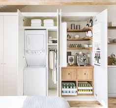 a washer and dryer sitting in a room next to each other on shelves