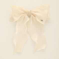 Add a touch of classic charm to your hairstyle with our Chic Pearl-Trimmed Bow Barrette. This elegant accessory features a sumptuous fabric bow, delicately edged with a string of pearls for a sophisticated finish. Adorned with a subtle, shining emblem, it’s the perfect choice for a refined look, whether you’re heading to the office or dressing up for a night out. Secure your locks with this timeless piece that effortlessly combines modern style with vintage glamour 100% Polyester Model measureme Bow Barrette, Casual Beach Wear, String Of Pearls, Your Hairstyle, Fabric Bows, Vintage Glamour, Elegant Accessories, New Arrival Dress, Shop Swimwear