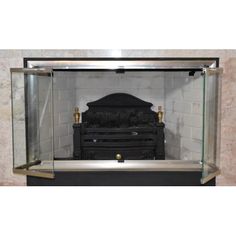 an old fashioned fireplace with a glass case on the front and back sides, in a marble walled room