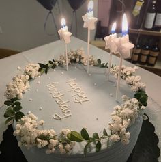 a birthday cake decorated with flowers and candles