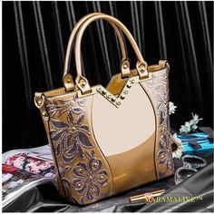 SPECIFICATIONSBrand Name: VRMMVROrigin: Mainland ChinaCN: GuangdongLining Material: POLYESTERMain Material: Patent LeatherPlace Of Origin: GUANG DONG ProvincePlace Of Origin: GUANG DONG ProvinceShape: Casual ToteOccasion: VersatileExterior: Silt PocketModel Number: CHRAARY-20240322-AClosure Type: zipperDecoration: embroideryDecoration: FLOWERSDecoration: diamondsHardness: HARDGender: WOMENPattern Type: FloralInterior: Interior Slot PocketInterior: Cell Phone PocketInterior: Interior Zipper Pocke Gold Tote Shoulder Bag For Party, Luxury Party Bag With Large Capacity, Luxury Large Capacity Party Bag, Luxury Large Capacity Party Bags, Gold Luxury Shoulder Bag With Large Capacity, Gold Embroidered Tote Bag, Gold Large Capacity Evening Bag For Party, Large Capacity Gold Evening Bag For Party, Large Capacity Gold Bag For Party