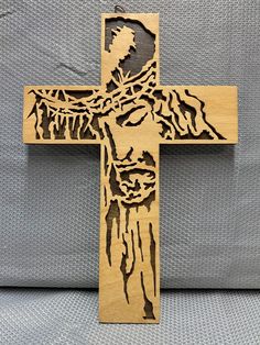 a wooden cross with jesus's face on it