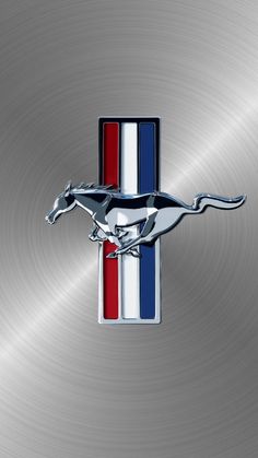 a chrome plate with a red, white and blue mustang emblem on it's side